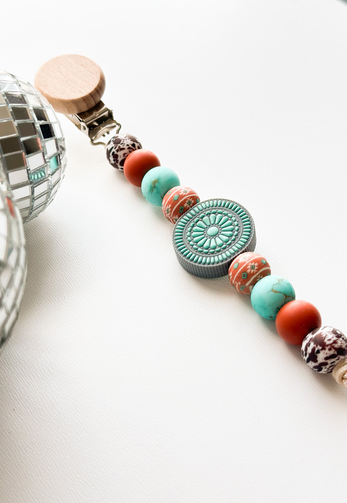 The turquoise junkie Pacifier Clip
